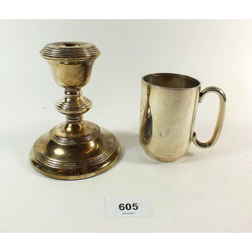 605 - A silver christening mug Birmingham 1915, 98g and a silver candlestick Birmingham 1959