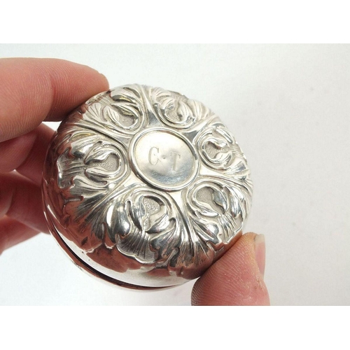 622 - A sterling silver covered yo yo with embossed decoration by L S M, 5.5 cm diameter