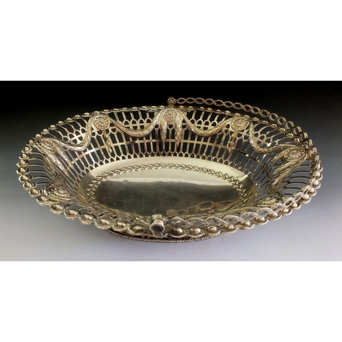 643 - A large silver cake basket with embossed swag decoration, London 1773, by Richard Mills, 675g