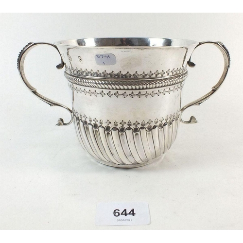 644 - A large Queen Anne silver porringer or caudle cup, London 1706 by John Abbott, with embossed decorat... 