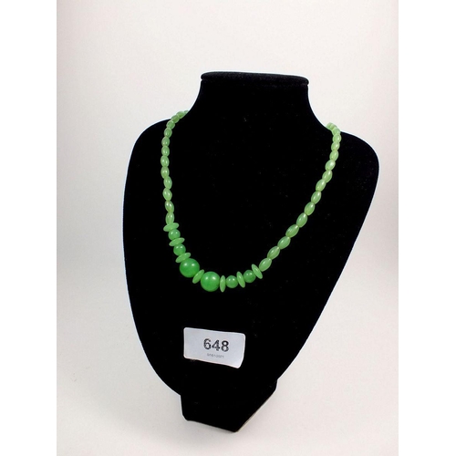 648 - A carved jade bead necklace