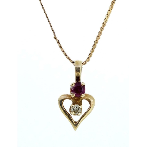 650 - A 10ct gold diamond and ruby set heart form pendant on fine chain