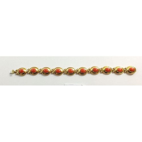 667 - An 18ct gold oval link bracelet set coral, 17g