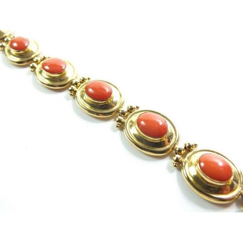 667 - An 18ct gold oval link bracelet set coral, 17g