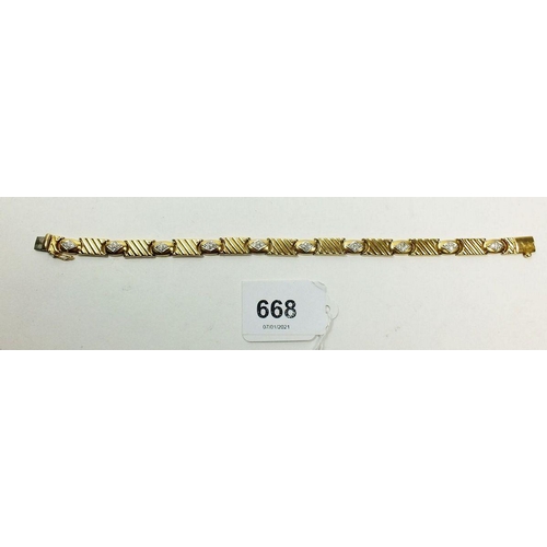 668 - An 18 carat gold link and diamond set bracelet, 20cm long, 18.8g