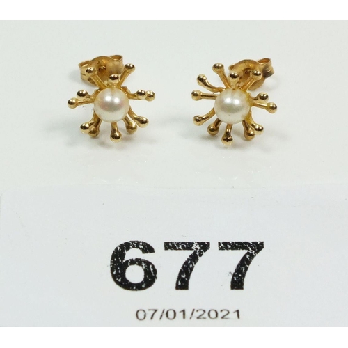 677 - A pair of 10ct gold and pearl earrings