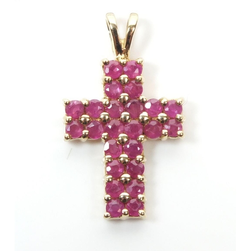 679 - A 9ct gold ruby set crucifix pendant, 2cm