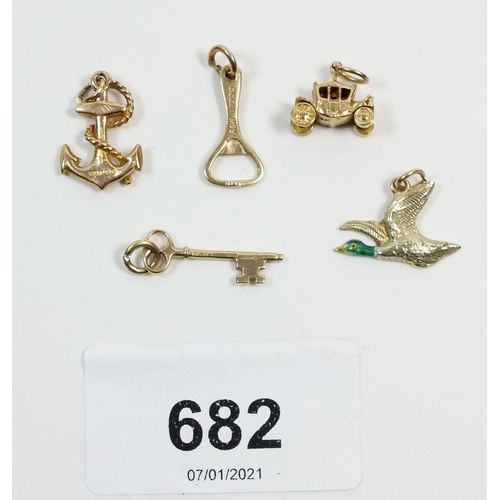 682 - Five 9 carat gold charms comprising key, anchor, carriage, bottle opener and duck