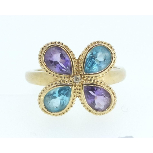 693 - A 14ct gold ring set blue topaz and amethyst - size M-N