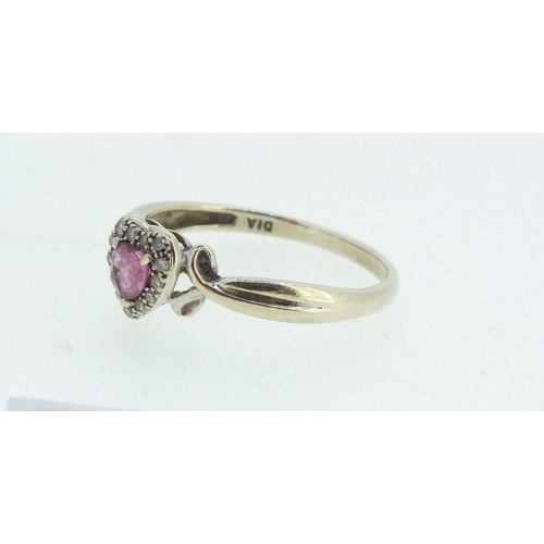 699 - A 9ct gold ring with amethyst heart form stone within chip diamond surround, Size L -1.5g