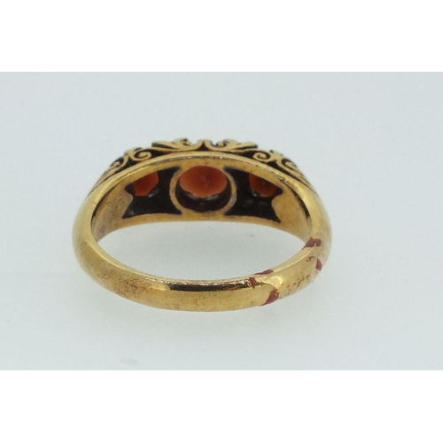 713 - A 9ct gold ring set three garnets - size O-P