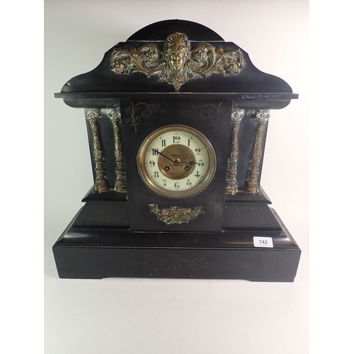 1099 - A Victorian large black slate mantel clock with gilt metal mask and architectural decoration