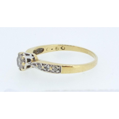 225 - An 18ct gold and platinum set diamond ring, the central stone 1/2ct on diamond set shoulders, size O... 