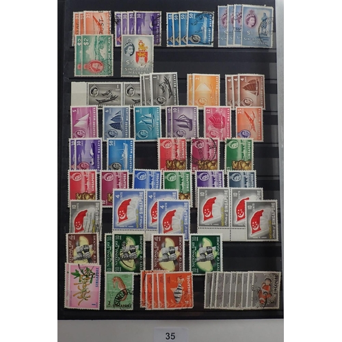 35 - Singapore: Large 30 page stock-book full of KGVI-QEII mint & used defin, commem and postage due. Inc... 