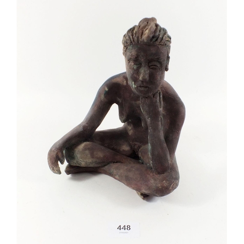 448 - A painted ceramic sculpture of a seated woman, 22cm