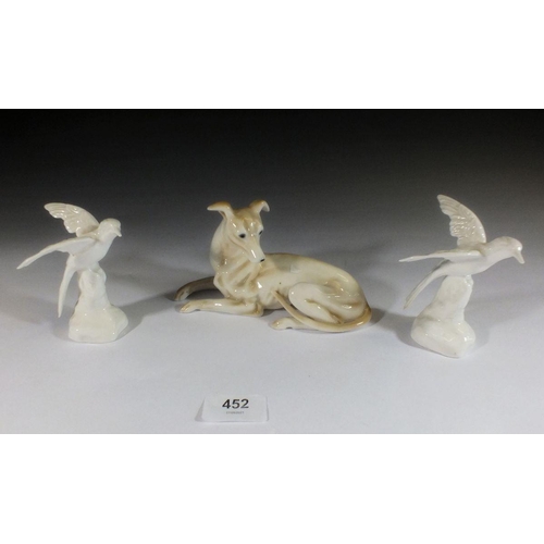 452 - A porcelain greyhound and two Staffordshire small kingfishers, 9cm tall