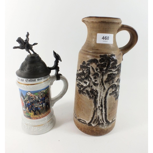 468 - A West German studio pottery jug and a military themed stein