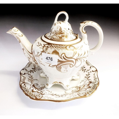 476 - A Victorian Rockingham style gilt and white teapot on matching plate