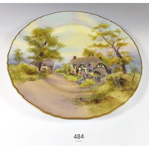 484 - A Royal Worcester plate painted 'Thatched Cottage at Wick' signed A Wallcraft, 27cm diameter