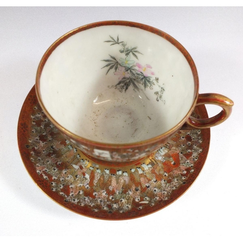 507 - A Japanese satsuma cup and saucer painted with the 