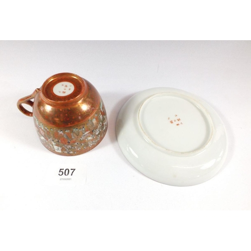 507 - A Japanese satsuma cup and saucer painted with the 