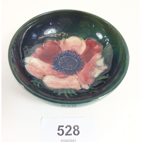 528 - A Moorcroft Green Anenome small bowl, 8cm diameter (restoration to rim)