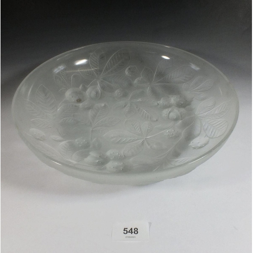 548 - A glass dish moulded horse chestnuts, 29cm diameter