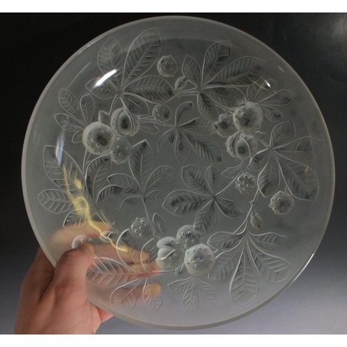 548 - A glass dish moulded horse chestnuts, 29cm diameter