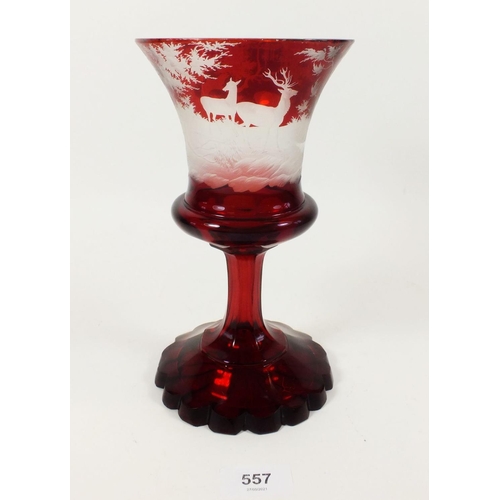 557 - A 19th century ruby glass large goblet with etched stag decoration, small chips, 22cm