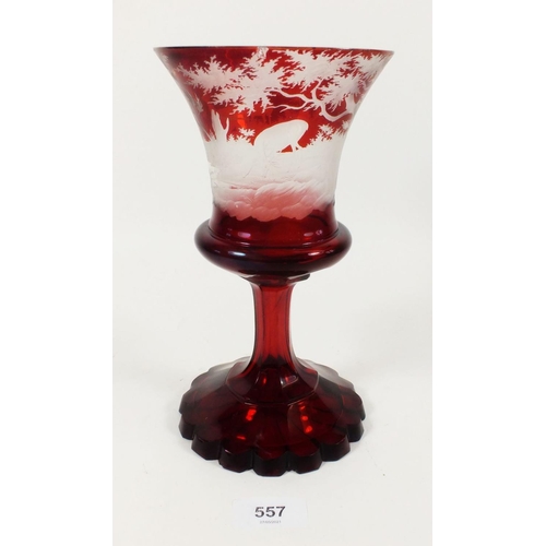 557 - A 19th century ruby glass large goblet with etched stag decoration, small chips, 22cm