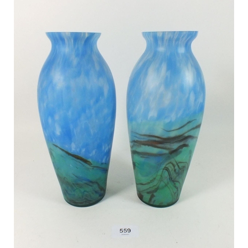 559 - A pair of mottled and clouded blue on green glass vases, 26cm