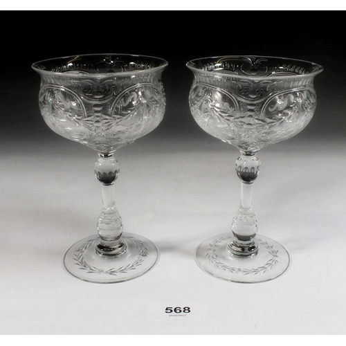 568 - A pair of 1920's Webb champagne glasses engraved with swags and ribbons - 14cm tall