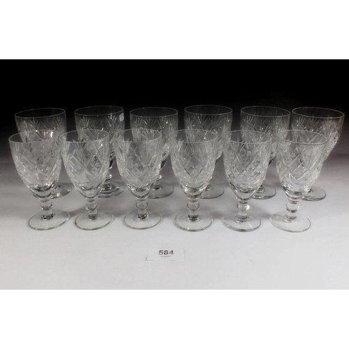 584 - A set of six cut glass wine glasses with a matching set of six sherry glasses