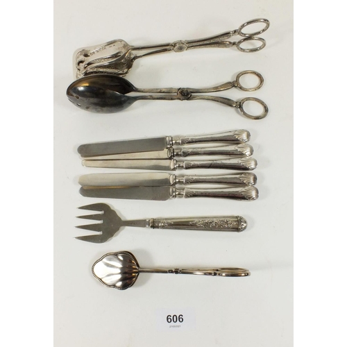 606 - A set of six silver handled tea knives, a silver plated cake fork and three pairs of cake tongs