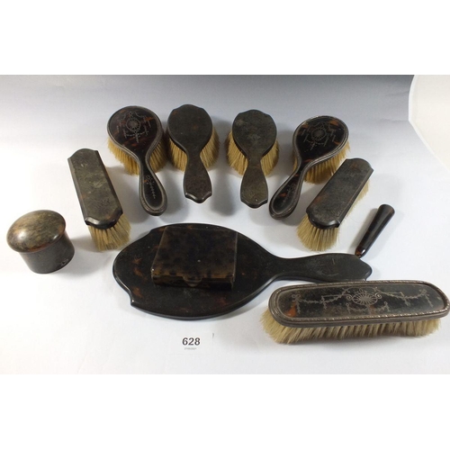 628 - Three silver and tortoishell brushes and a group of tortoiseshell brushes, mirror etc.