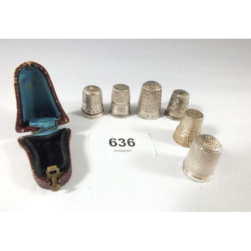 636 - A group of six silver thimbles and a thimble case