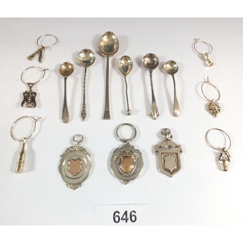 646 - Six silver cruet spoons and a set of six silver plated drinks charms and three silver sports medals