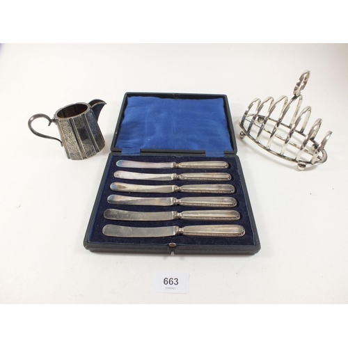 663 - A set of six silver handled tea knives cased and a silver plated toast rack and jug