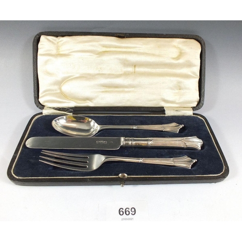 669 - A silver three piece christening set comprising: spoon, knife and fork, cased, London 1893