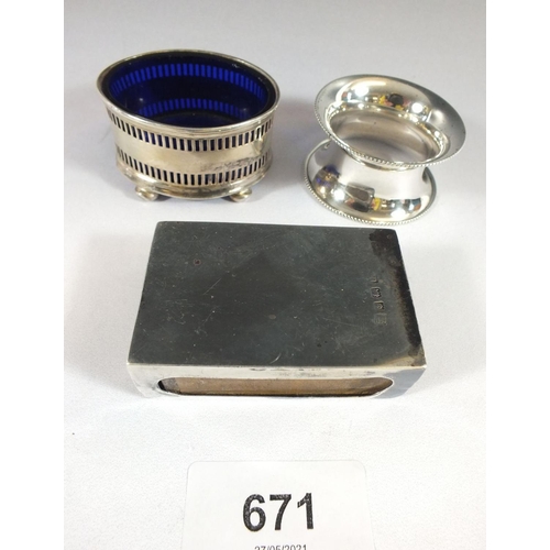 671 - A silver napkin ring, salt pot and matchbox holder, 65g