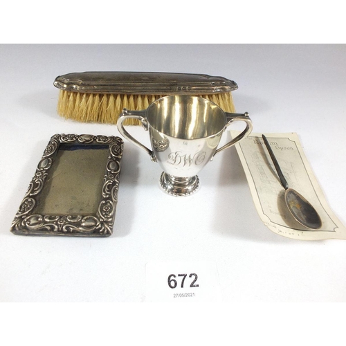 672 - A group of silver items including miniature silver trophy cup, 50g, a silver miniature photograph fr... 