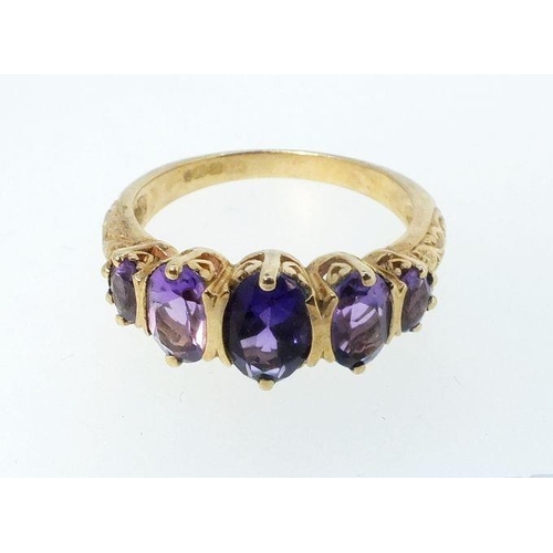 767 - A 9ct gold ring set five amethysts, size N, 3g