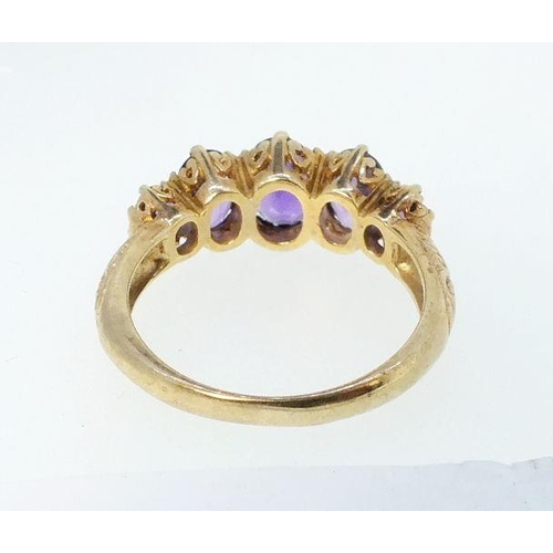 767 - A 9ct gold ring set five amethysts, size N, 3g