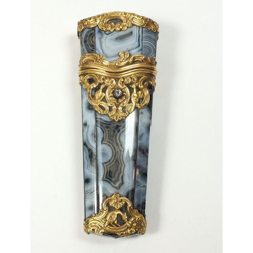 773 - An 18th century grey agate etui mounted with gold scrollwork decoration and set diamond, the hinged ... 