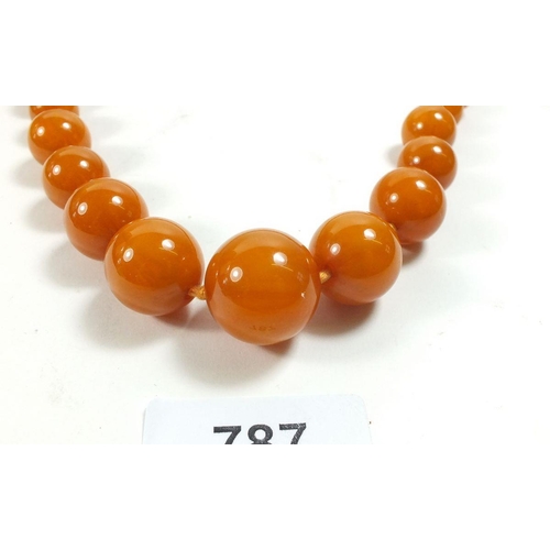 787 - A yellow simulated amber necklace, 88cm 84g