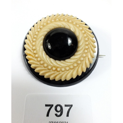 797 - A 19thC Whitby jet and ivory circular brooch, 5cm diameter