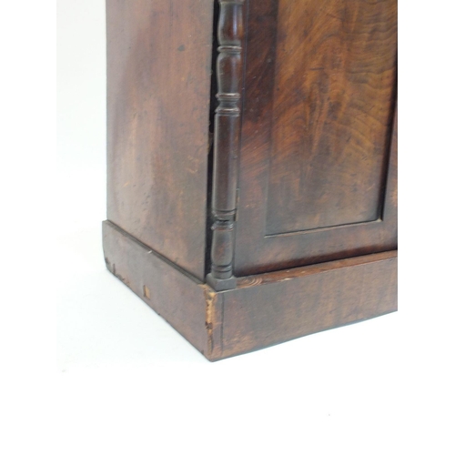 1024 - A Victorian mahogany bookcase of small proportions with two glazed doors over drawer and cupboard