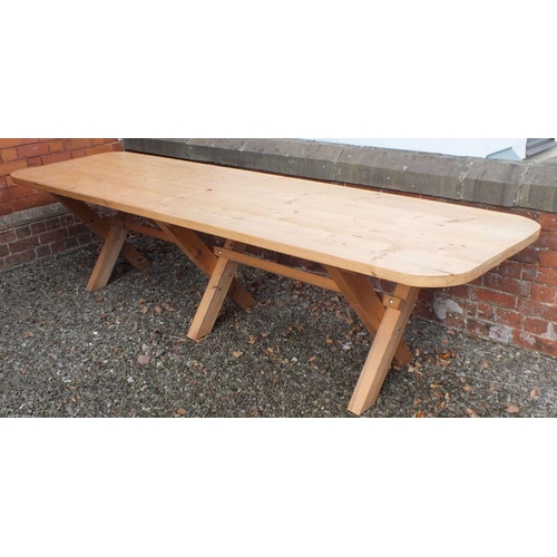 1028 - A large solid pine refectory style banqueting table on X frame supports, 320cm long x 88cm wide x 76... 