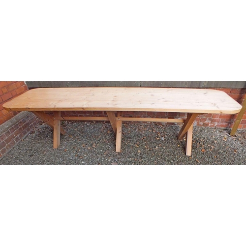 1028 - A large solid pine refectory style banqueting table on X frame supports, 320cm long x 88cm wide x 76... 