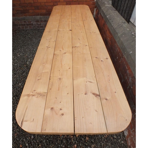 1028 - A large solid pine refectory style banqueting table on X frame supports, 320cm long x 88cm wide x 76... 